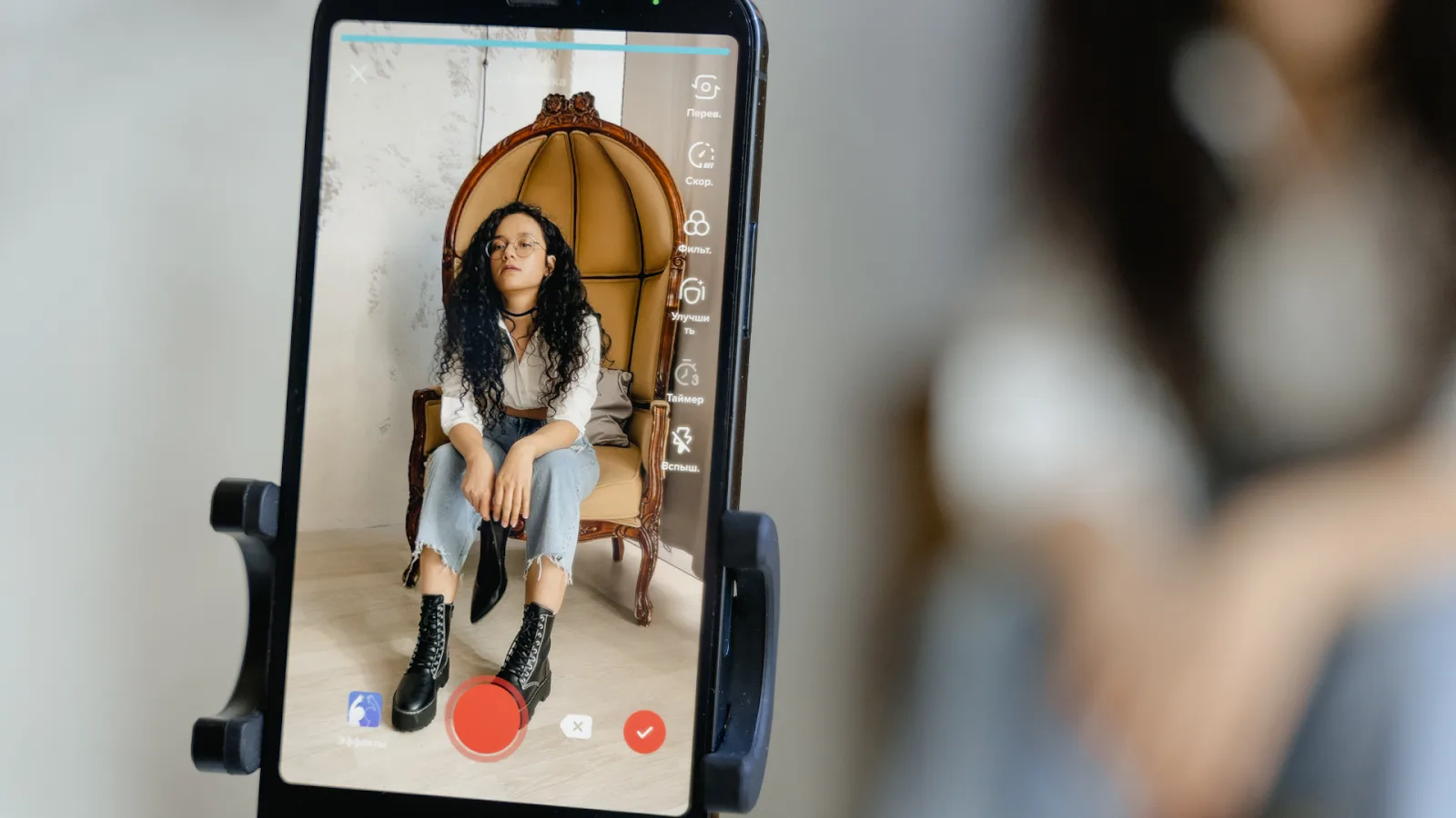 TikTok affiliate program content creator filming a seated video on a smartphone screen