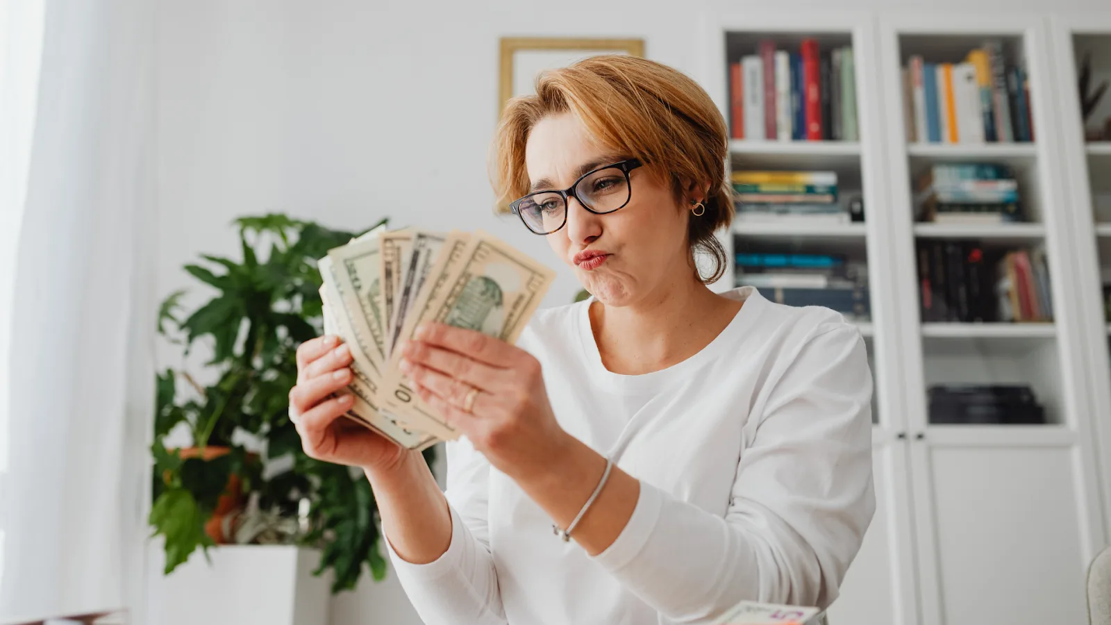 TikTok affiliate program creator counting earnings from content monetization at home