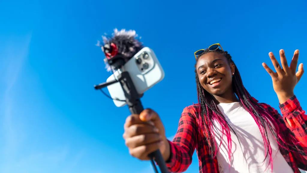 Creator filming content on smartphone for social media monetization